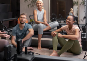 people pilates reformer class exercising their bodies (1)