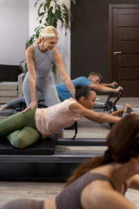 people pilates reformer class exercising their bodies (2)