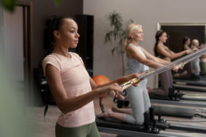 people pilates reformer class exercising their bodies